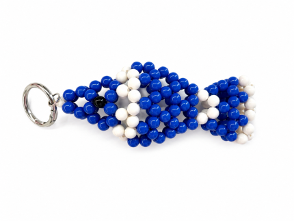 Blue and white handmade evil eye fish bag charm on a white background