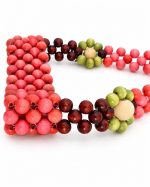 Close-up of pink, burgundy and olive wooden beads on the Berry Bloom cup carrier