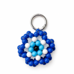 Blue handmade Greek mati evil eye bag charm on a white background