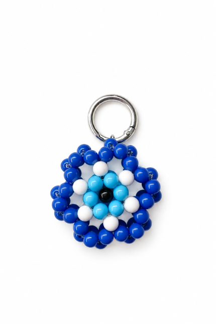 Blue handmade Greek mati evil eye bag charm on a white background