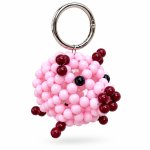 Pink beaded pig bag charm with burgundy details, black eyes and a silver-tone ring on a white background