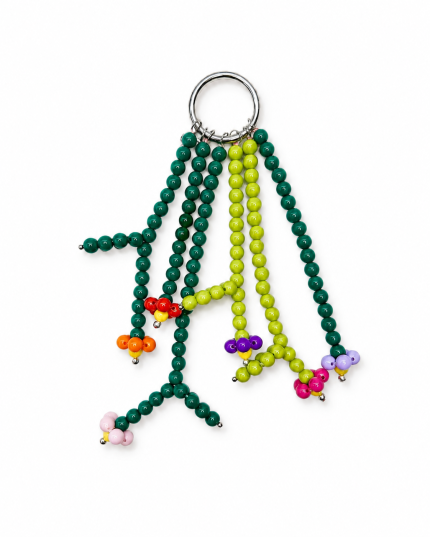 Colorful handmade beaded flower bag charm on a white background