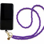 Purple handmade acrylic bead phone strap displayed with a phone