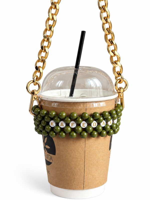 Olive green KAFEDAKI beaded cup carrier with a gold-tone chain holding a takeaway coffee cup