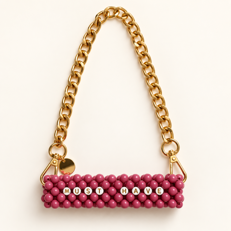 Dusty pink MUST HAVE beaded cup carrier with a gold-tone chain laid flat