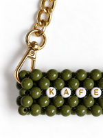 Close-up of the gold-tone chain and clasp on the KAFEDAKI beaded cup carrier