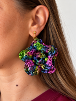 Multicolor raffia flower statement earring in blue, green, purple and pink worn on the ear