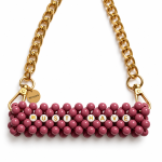 Close-up of MUST HAVE letter beads, dusty pink beadwork and gold-tone clasps