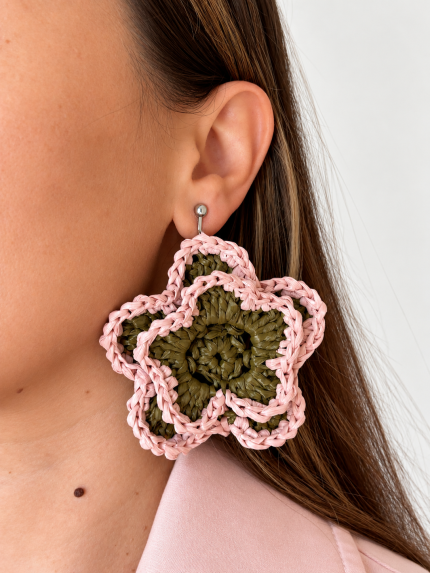 Pink and olive green open bloom raffia flower earring worn on the ear with a silver-tone fastening