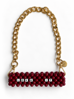 Burgundy LOVE IT beaded cup carrier with a gold-tone chain laid flat without a cup