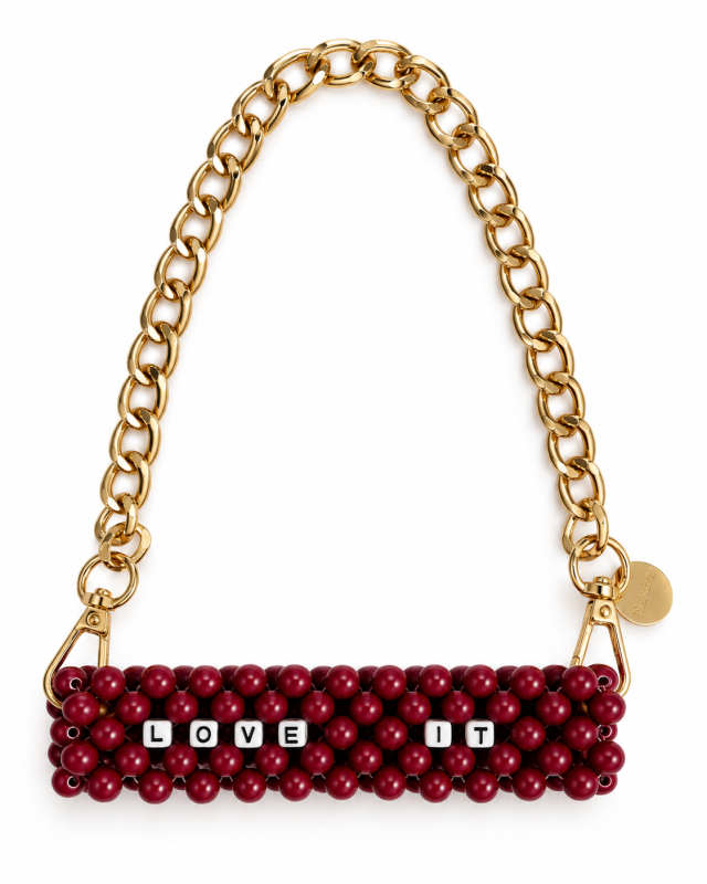 LOVE IT lettering on a burgundy beaded cup carrier with a gold-tone chain and clasps